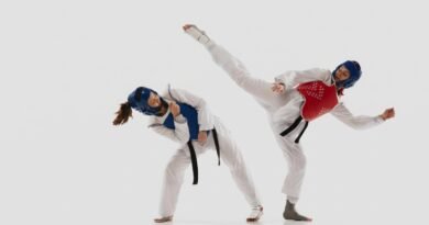 Two AAU Taekwondo competitors sparring at a sanctioned tournament, illustrating AAU Taekwondo membership requirements