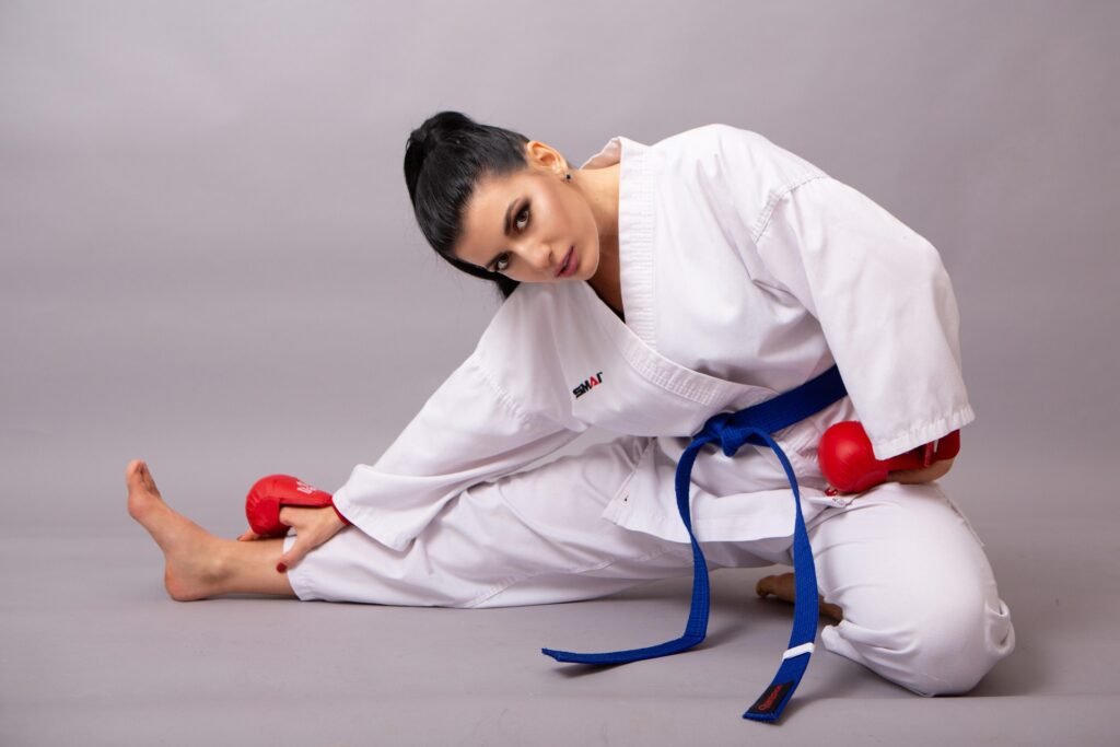 Taekwondo student wearing a blue belt practicing sparring drills during training