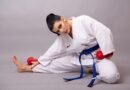 Taekwondo student wearing a blue belt practicing sparring drills during training