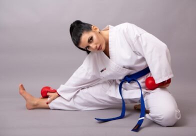 Taekwondo student wearing a blue belt practicing sparring drills during training
