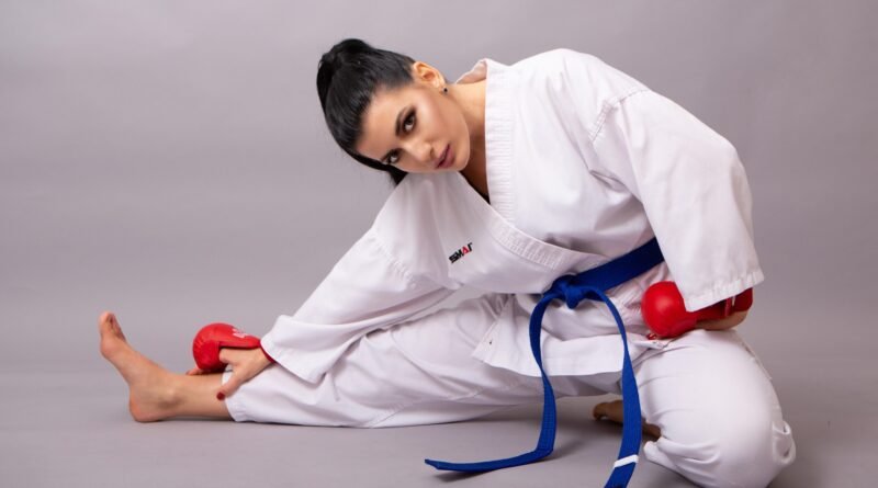 Taekwondo student wearing a blue belt practicing sparring drills during training