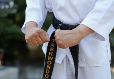 How Long Does It Take to Get a Black Belt in Taekwondo? | Dan Ranks Explained Taekwondo practitioner wearing a black belt demonstrating a high kick during training