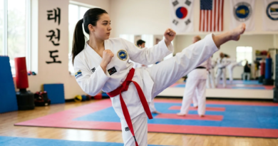 Taekwondo practitioner wearing a red belt performing a high side kick during training
