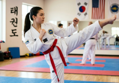 The Taekwondo Red Belt: Why This Rank Separates the Dedicated from the Determined Taekwondo practitioner wearing a red belt performing a high side kick during training