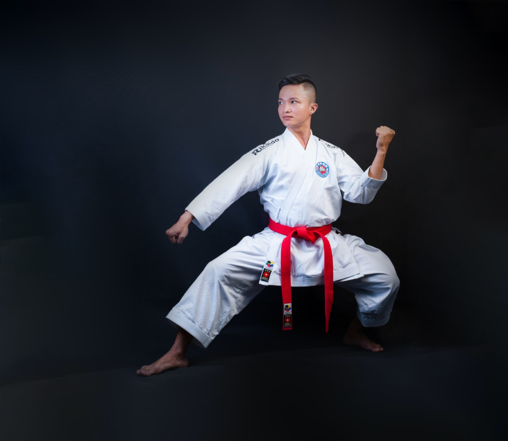Taekwondo student demonstrating the Red Belt Form Taegeuk Chil Jang tiger stance and technique
